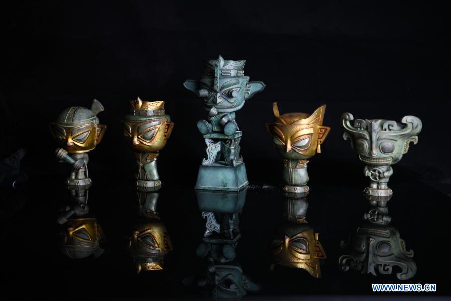 Toy figures are pictured at Zeng Zhou's workshop in Chengdu, southwest China's Sichuan Province, Feb. 4, 2021. Zeng Zhou is a 31-year-old independent designer working on toy figure design. Inspired by a visiting experience at Sanxingdui Museum in Sichuan, Zeng decided to design model figures imitating bronze relics of the Sanxingdui Ruins, which are believed to be remnants of the Shu Kingdom dating back 2,600 years to 4,800 years, blending traditional Chinese culture with fashion toys. Zeng Zhou is now dedicated to optimizing his design and promoting mass production of his toy figures. 
